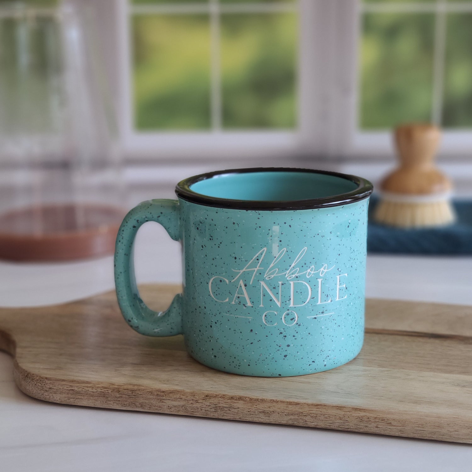Abboo Candle Co logo teal colored campfire ceramic mug