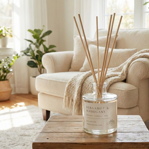 Diffuser with reeds on a wooden table in a bright living room