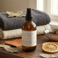 leather bay leaf room spray with soft blankets and dried citrus