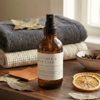 leather bay leaf room spray with soft blankets and dried citrus
