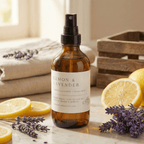 lemon lavender room spray surrounded by fresh lemons and lavender sprigs