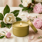 Gold Tin Candle surrounded by magnolia and peony flowers