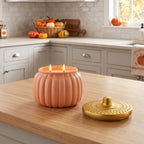 peachy pink muted orange ribbed ceramic pumpkin candle in kitchen
